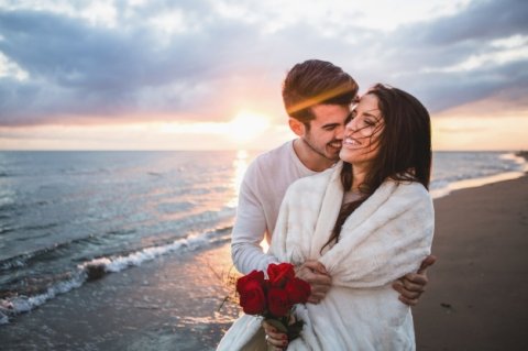 Smiling Couple Walking Beach With Bouquet Roses Su