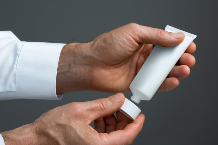 Mans Hands With White Cream Tube