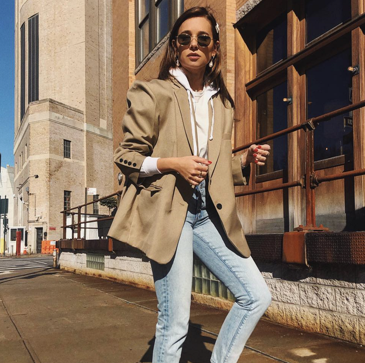 Hoodie is paired with Jeans and a short jacket