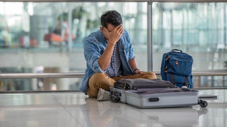 Man Packing Luggage At Airport
