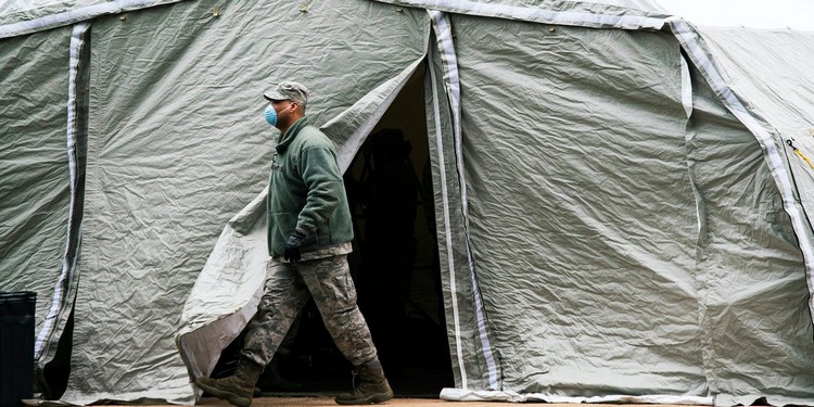 An Air Force Member Exits A Tent Builded As Makesh