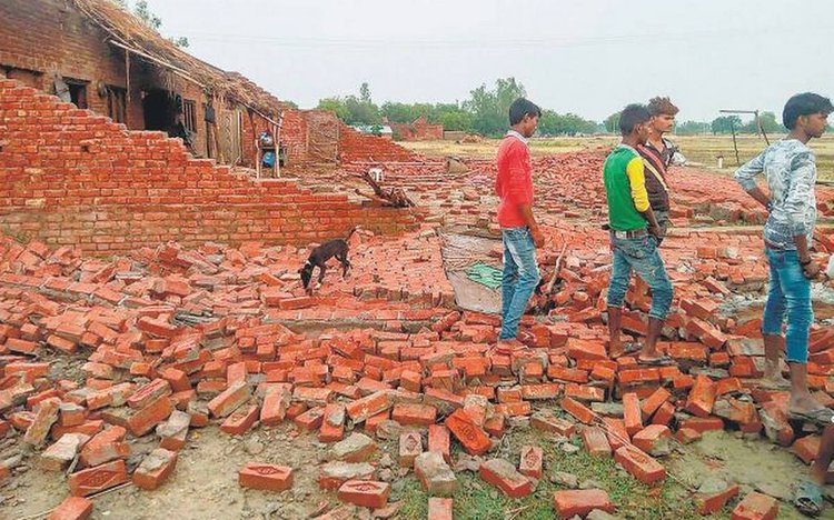 Villagers Inspect A House That Collapsed After A T