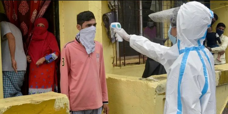 An Indian Resident Has His Temperature Checked By